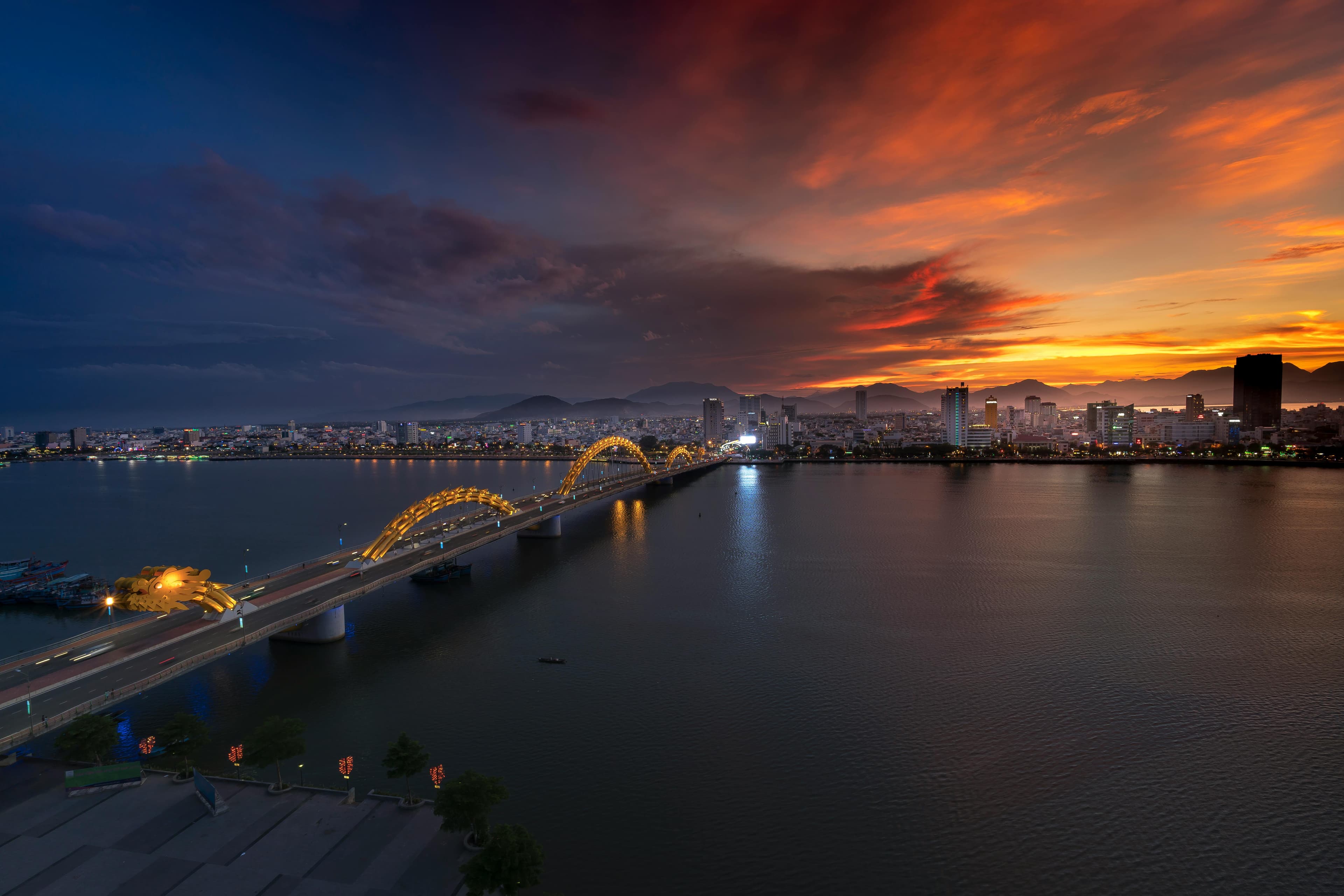 The Dragon Bridge illuminated at sunset over the Han River in Da Nang Vietnam
