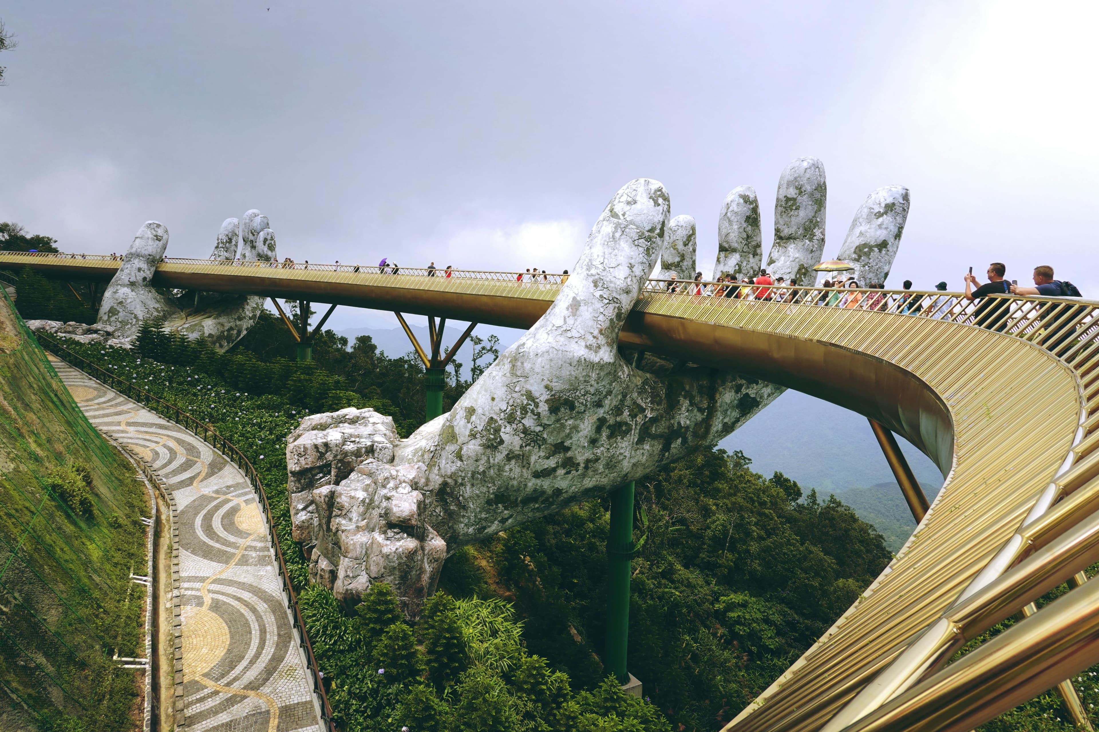 The iconic Golden Bridge held by giant stone hands at Ba Na Hills near Da Nang Vietnam
