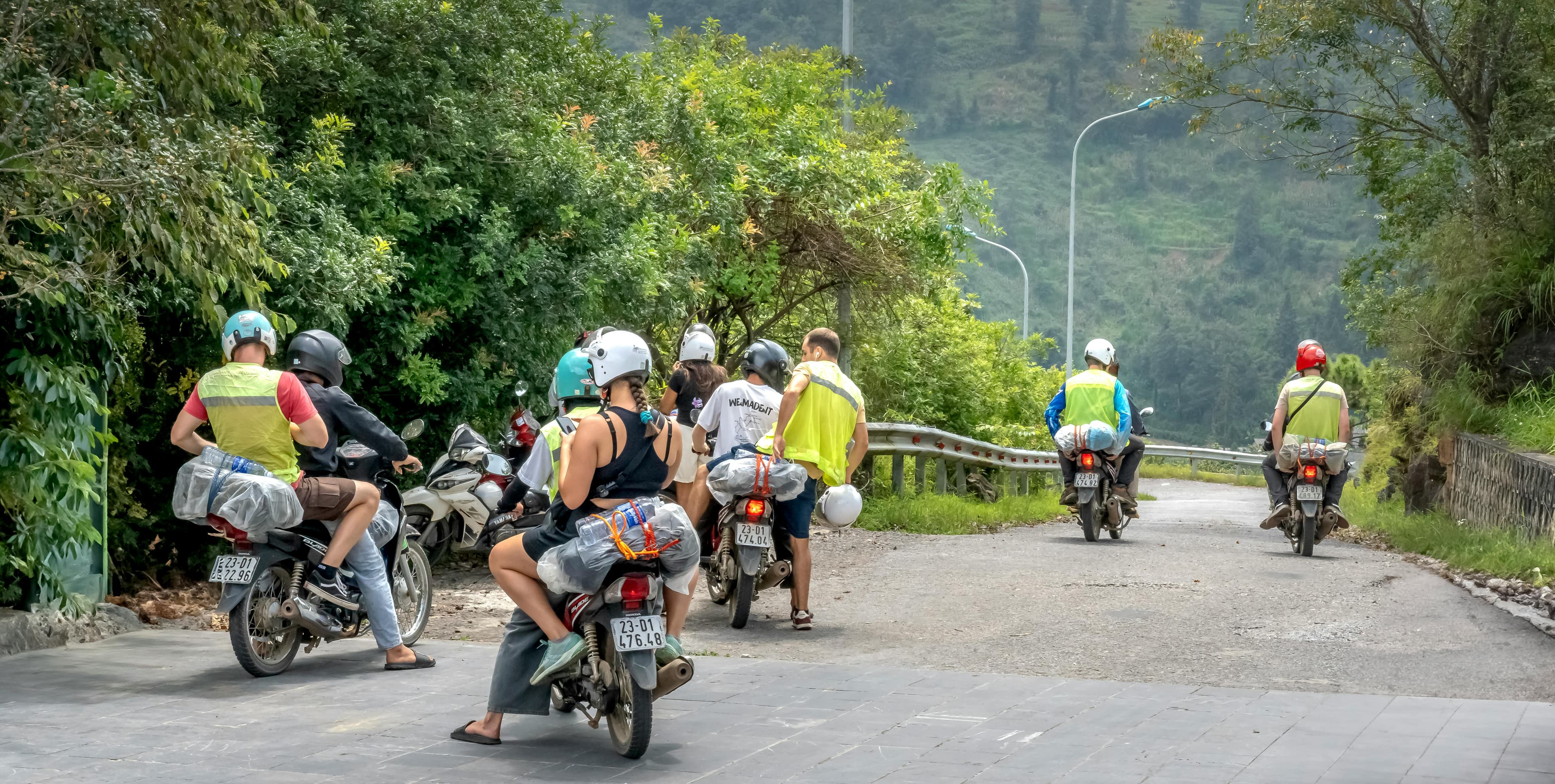 Group of motorbike riders with Easy Rider guides on the mountain roads near the Hai Van Pass Vietnam