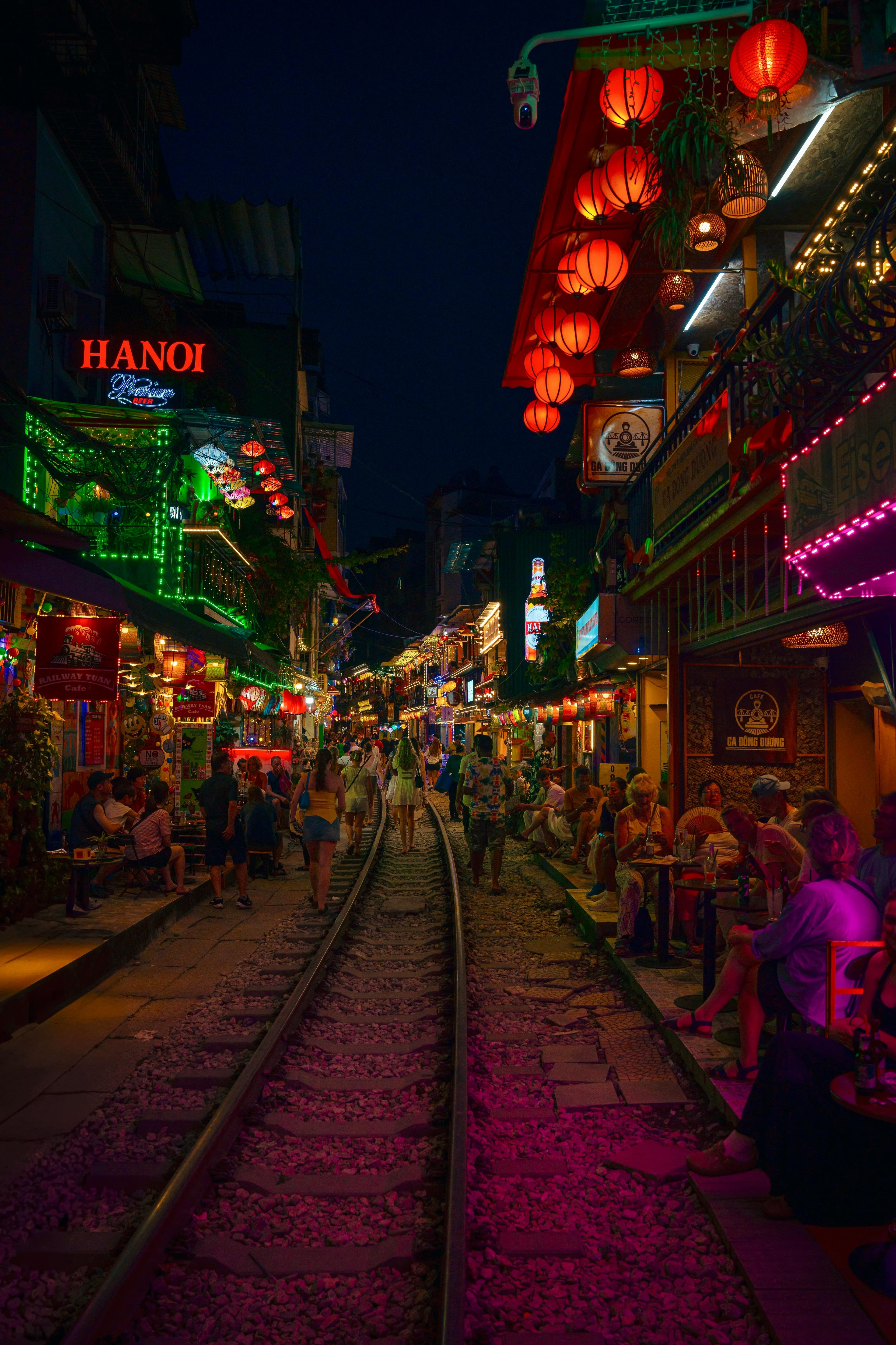 Hanoi Train Street at night with red lanterns and traditional cafes