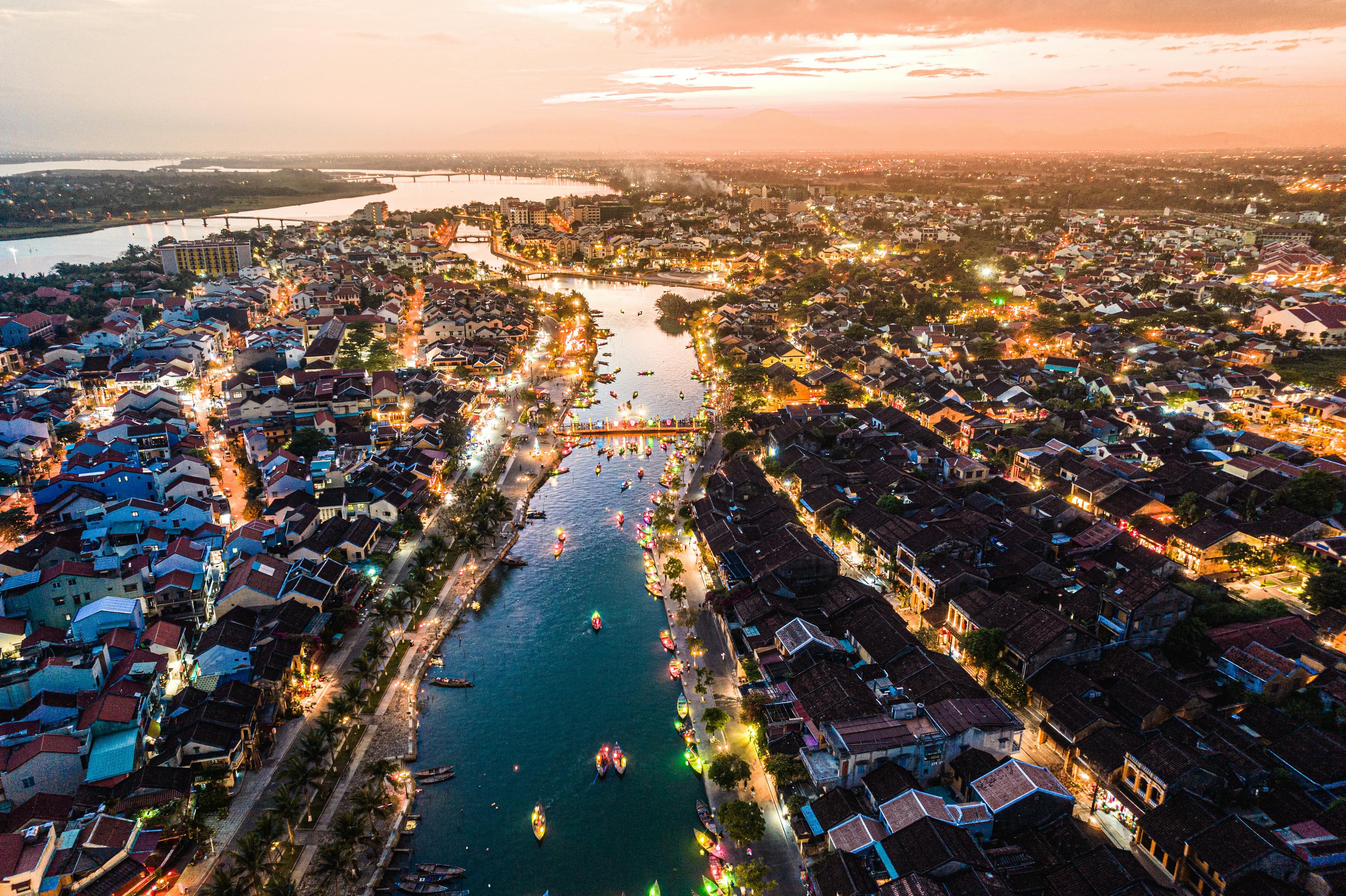 Aerial view of Hoi An Ancient Town illuminated by lanterns at night along Thu Bon River