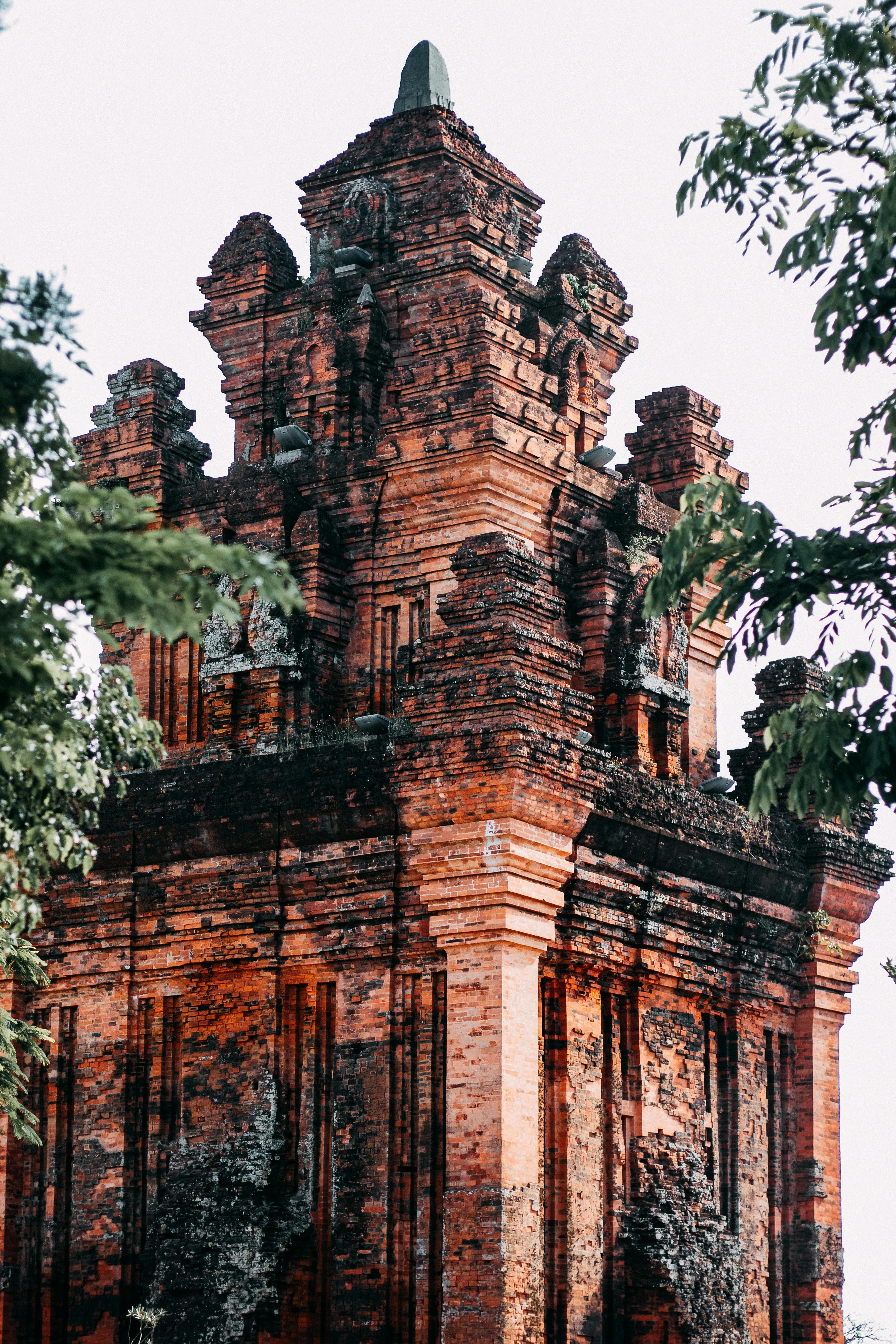 Ancient red brick Cham temple towers at My Son Sanctuary surrounded by jungle in Vietnam