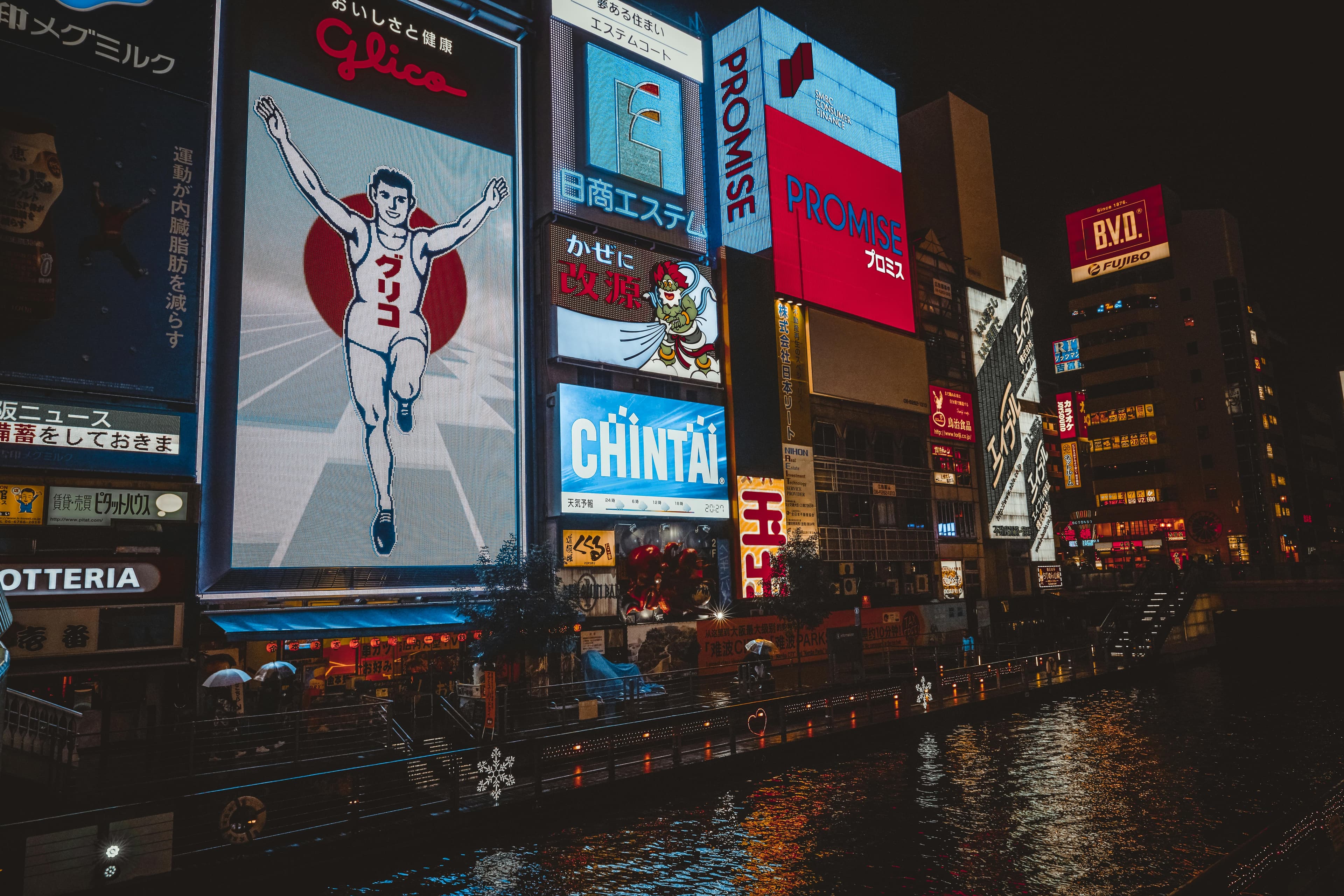 Dotonbori Glico running man billboard neon lights canal Osaka night entertainment district