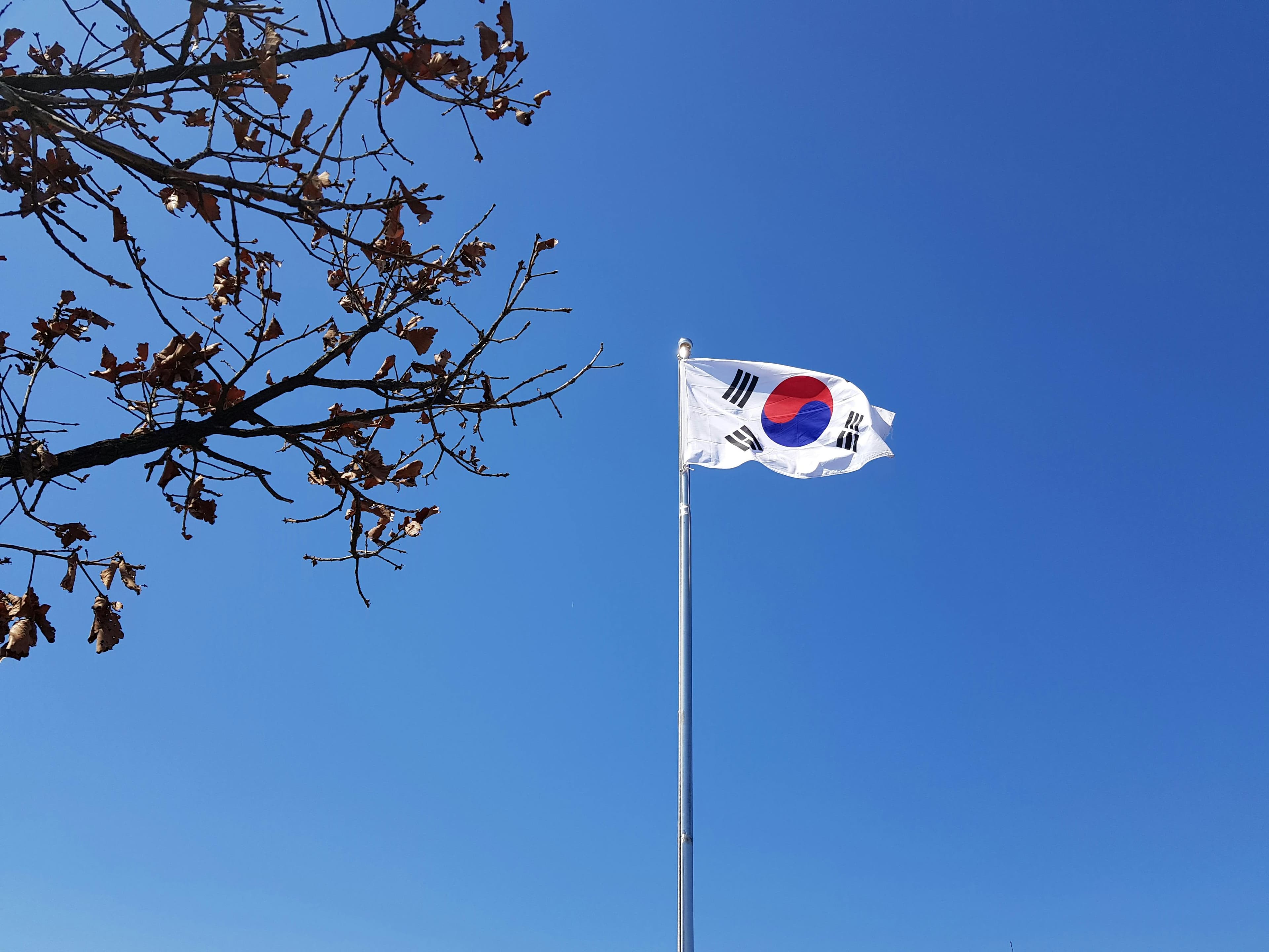 DMZ border fence and guard post between North and South Korea with warning signs