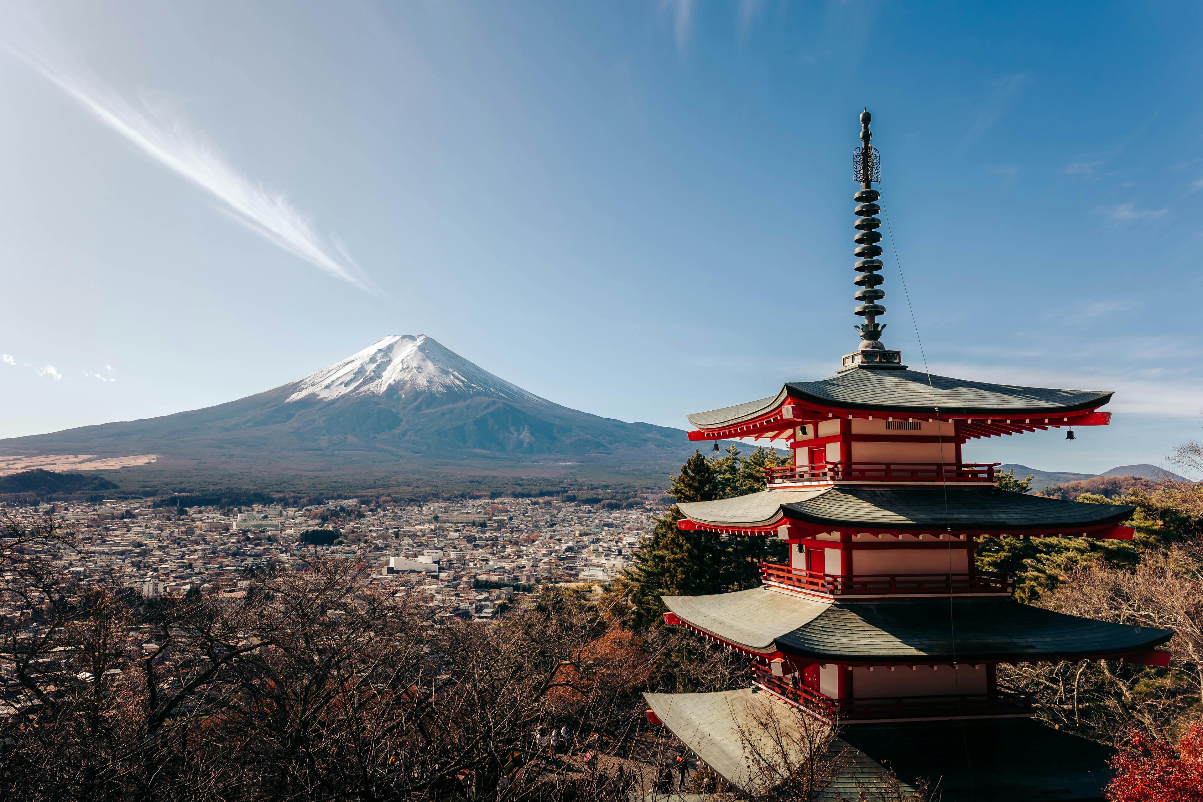 Mount Fuji with snow cap and red Chureito Pagoda in foreground on a clear winter day from Tokyo day trip