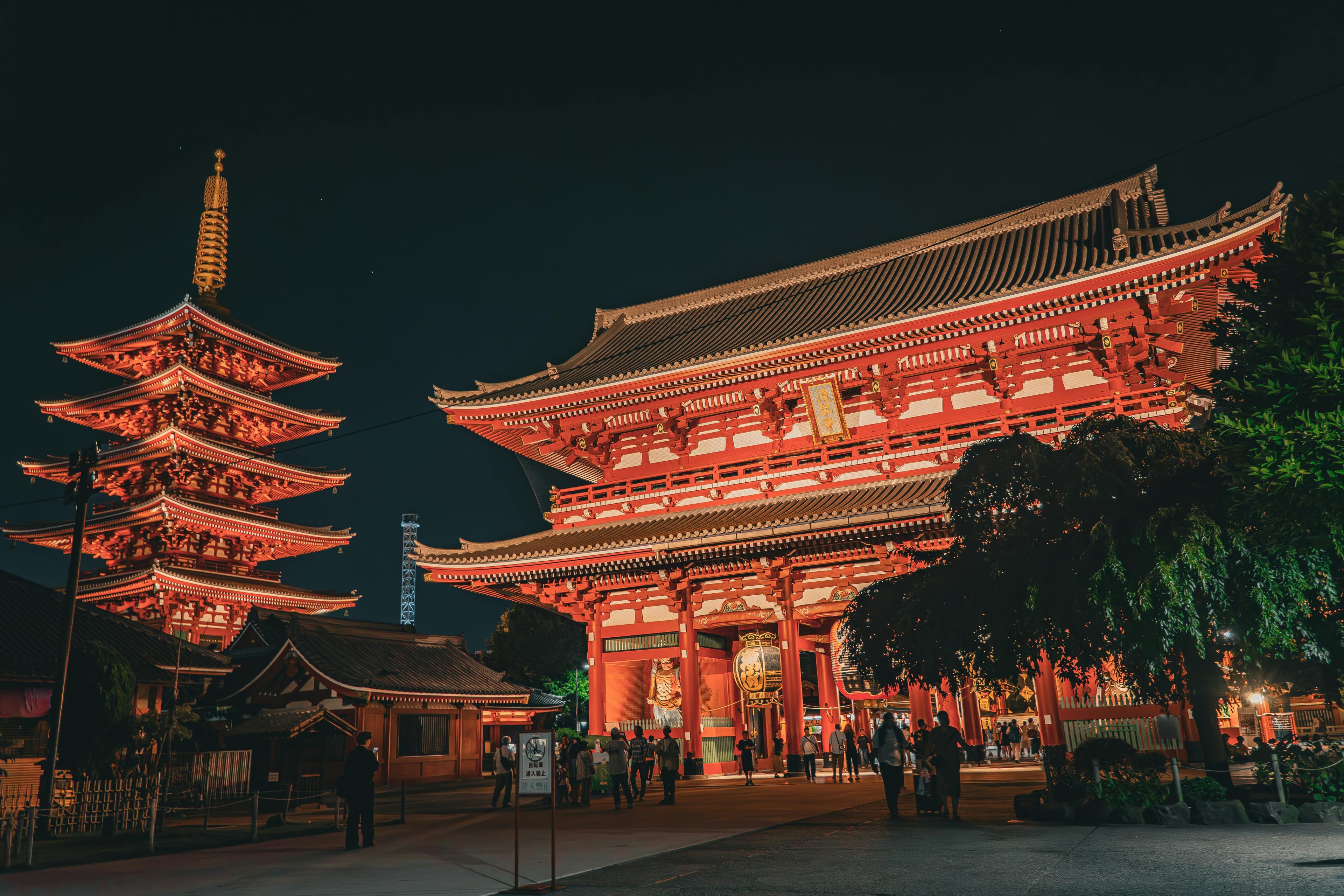 Senso-ji temple illuminated red at night with five-story pagoda in Asakusa Tokyo