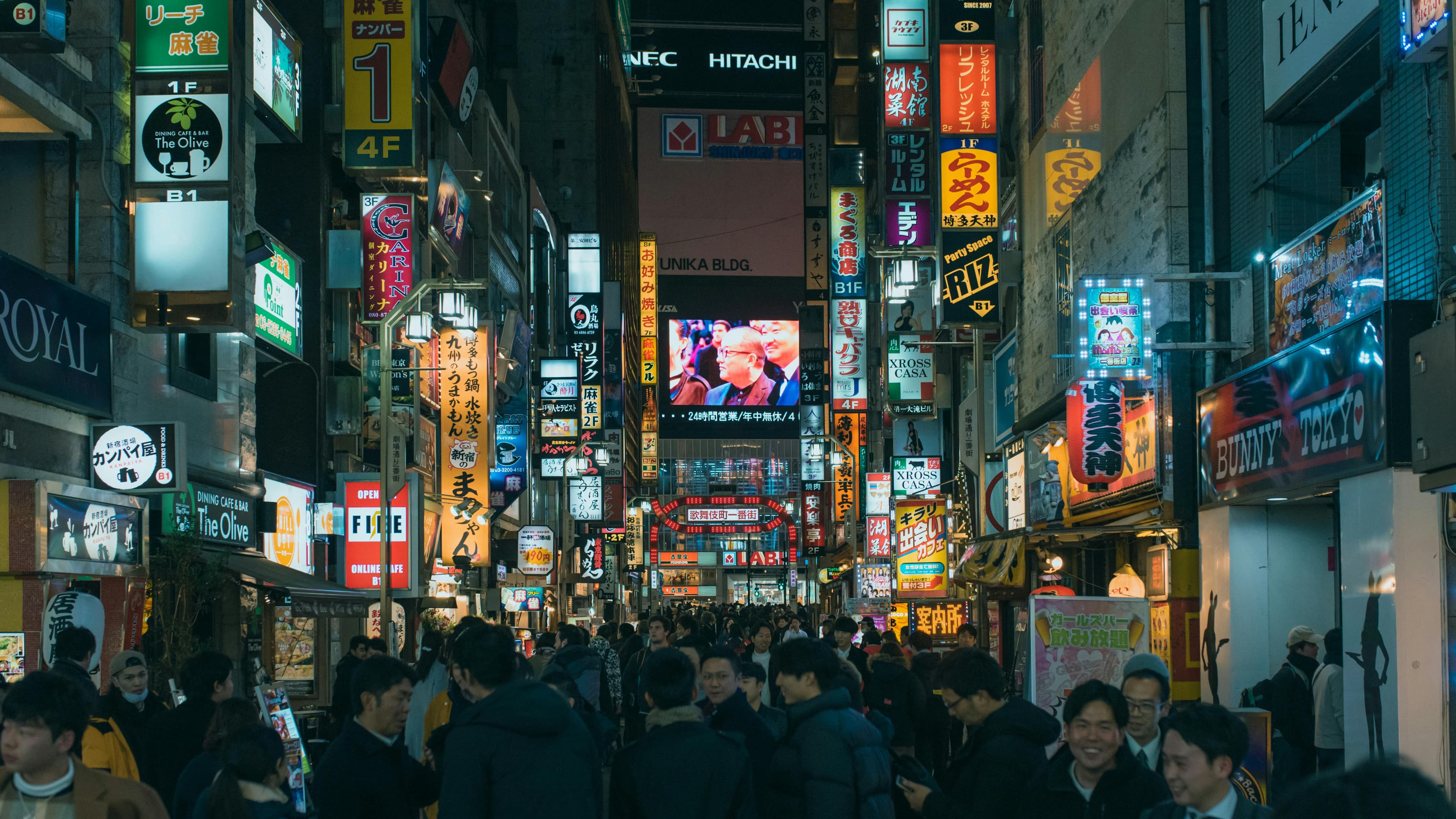 Shinjuku Tokyo narrow street with vintage lanterns pachinko signs and kanji neon signage at dusk